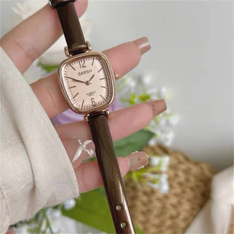 oval face watch with brown leather band