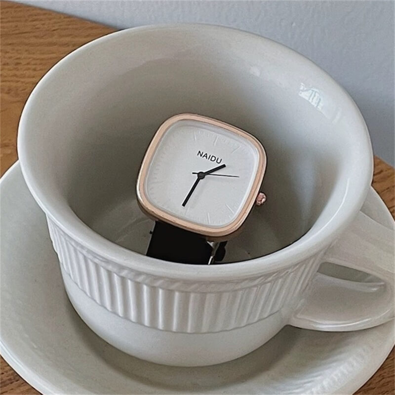 Rose gold square face with black band