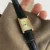 Classic black leather square Roman numeral gold dial watch