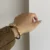 Vintage Gold Oval Watch for Women Roman Numeral Dial Bangle Watch