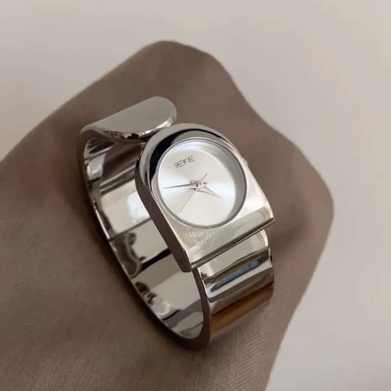 women's watches803-1 This stunning ladies' watch features a sleek silver-tone arched case paired with a clean, minimalist silver dial. Designed with a high-polish silver bangle band, it offers a perfect balance of modern elegance and chic style. Designed for women who love trendy, contemporary accessories, this versatile everyday watch adds a cool, polished touch to any outfit. It serves as an eye-catching bracelet watch for both daily wear and special occasions.